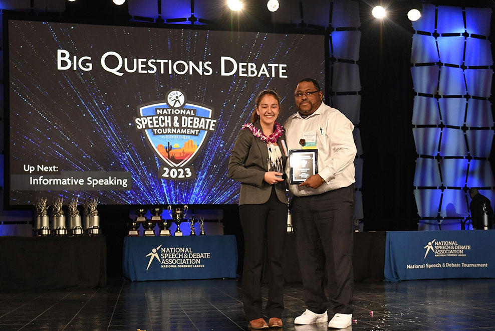 Student and Coach on stage at the National Tournament