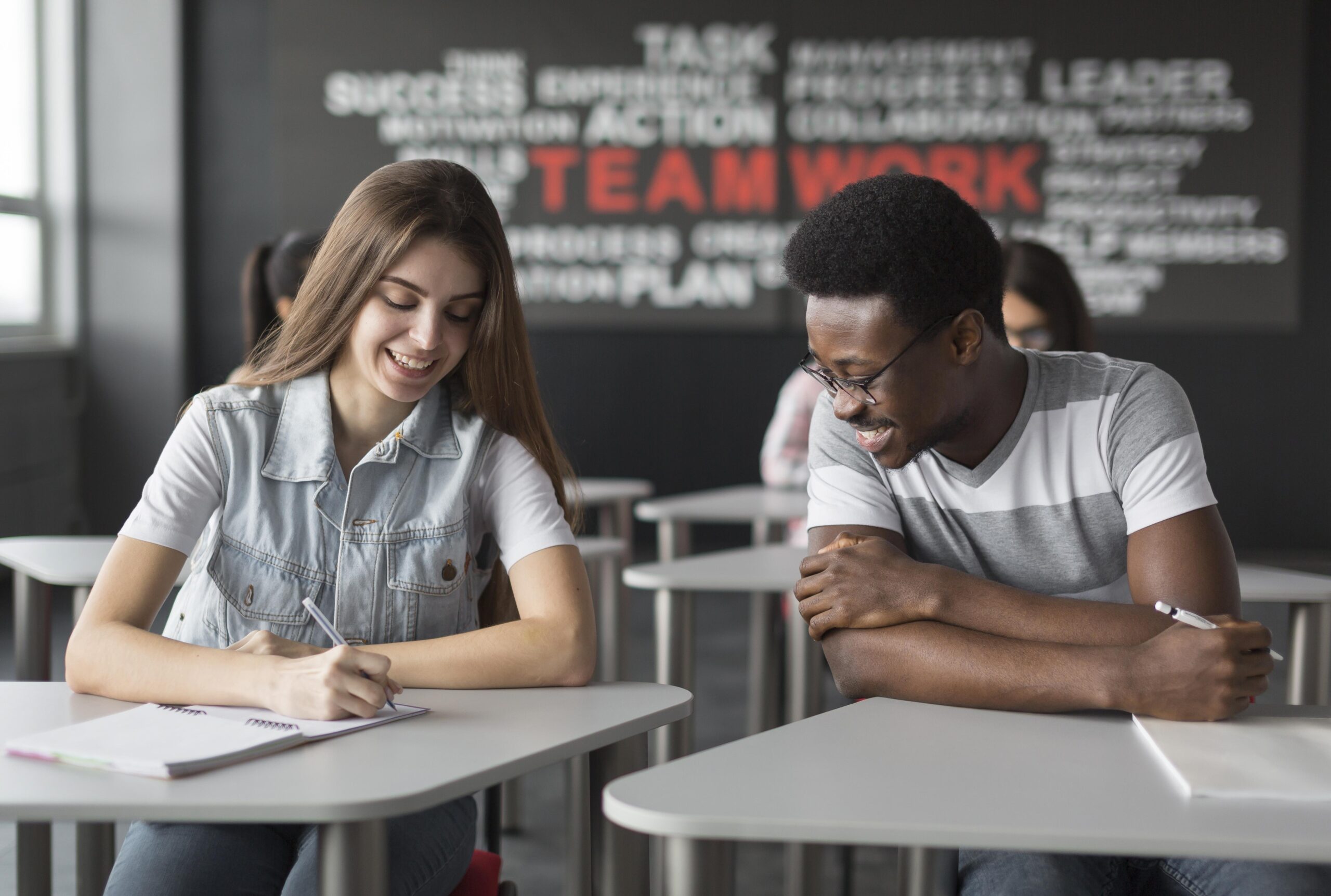 Two students working in a classroom Two students working in a classroom