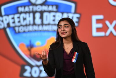 Student speaking on stage at the National Tournament
