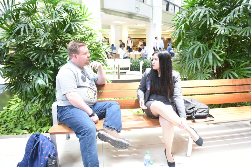 Coach and student sitting on a bench