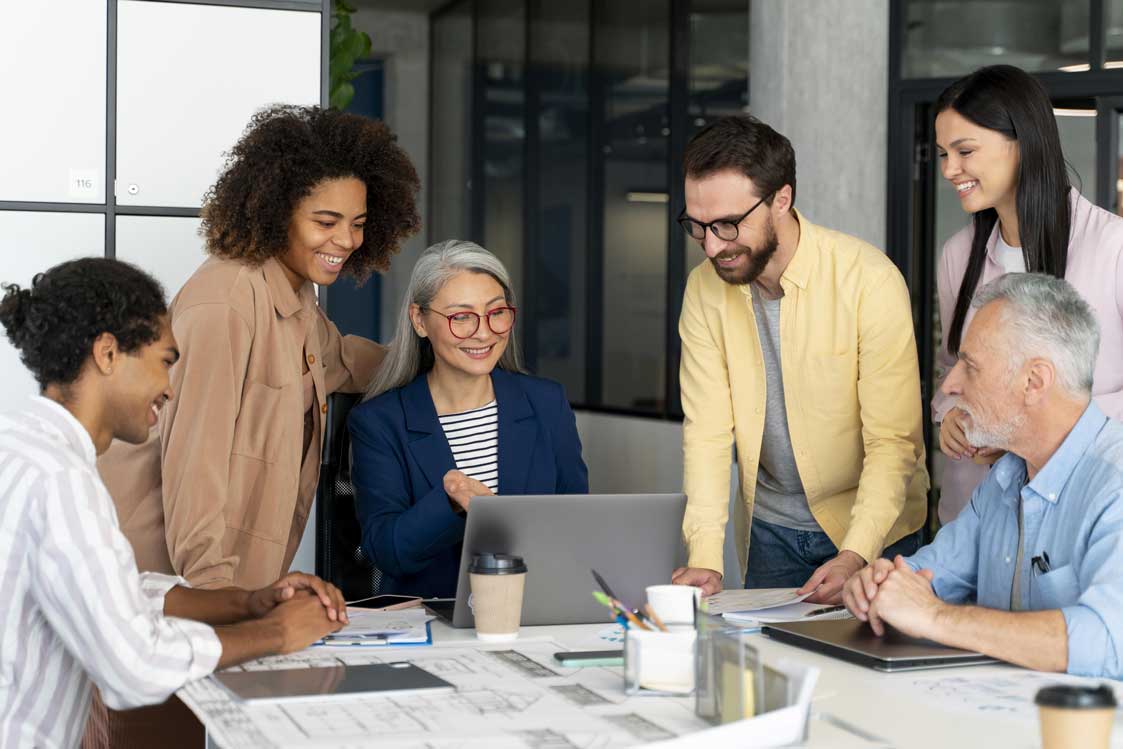 Group of people working together in an office Group of people working together in an office