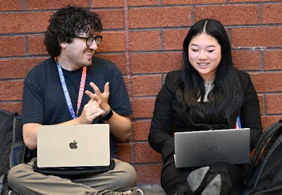Coach and a student sitting together talking