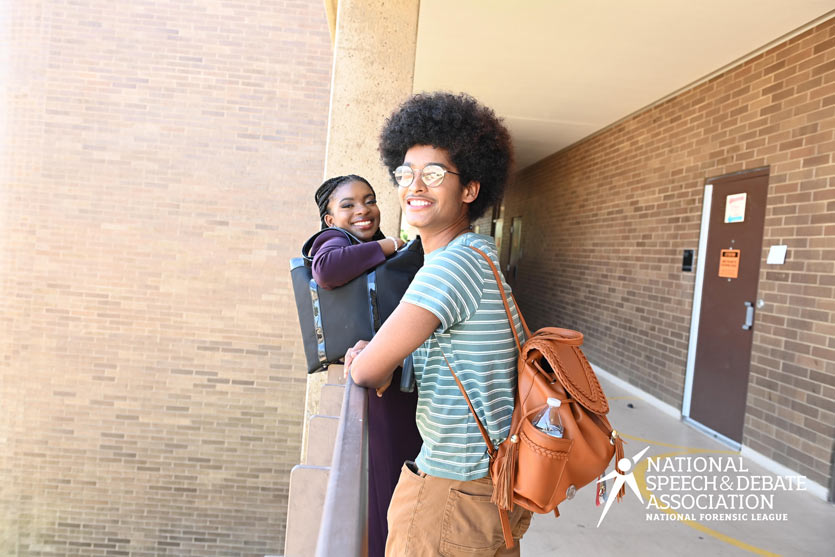 Two students standing outside at a school at the National Tournament