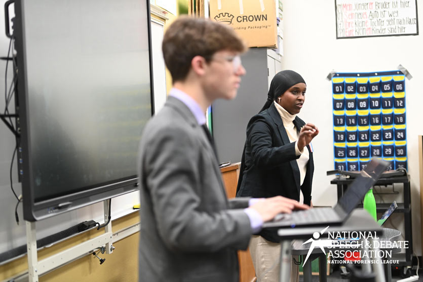 Two students competing in a classroom at the National Tournament