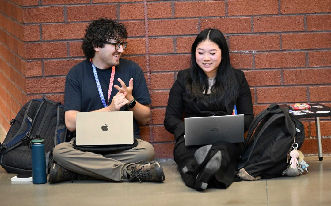 Coach and a student sitting together talking