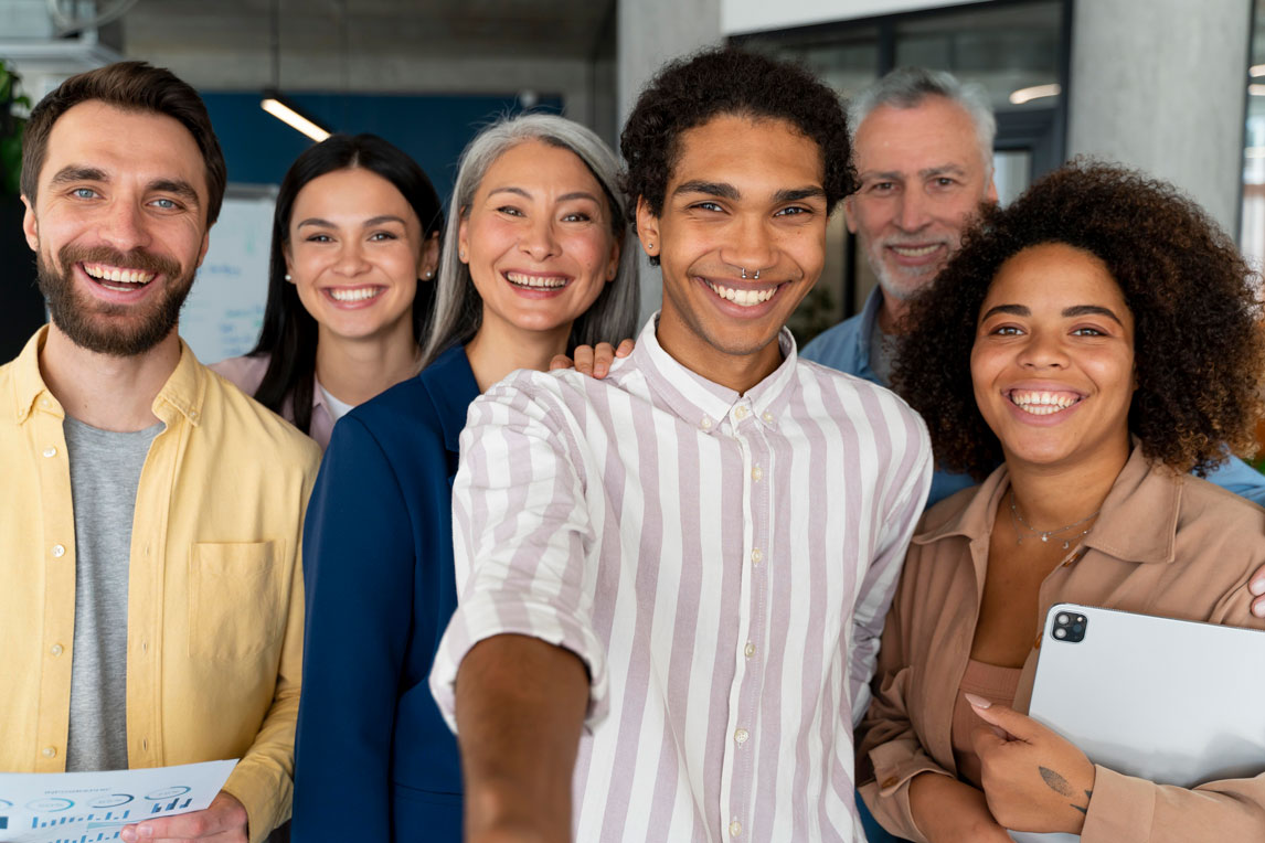 Group of people standing together looking at the camera smiling