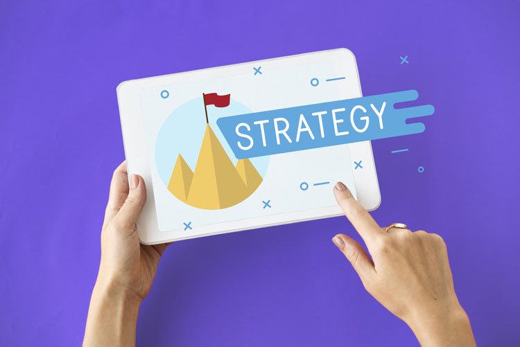Two hands holding a board with the word "Strategy". Two hands holding a board with the word "Strategy".
