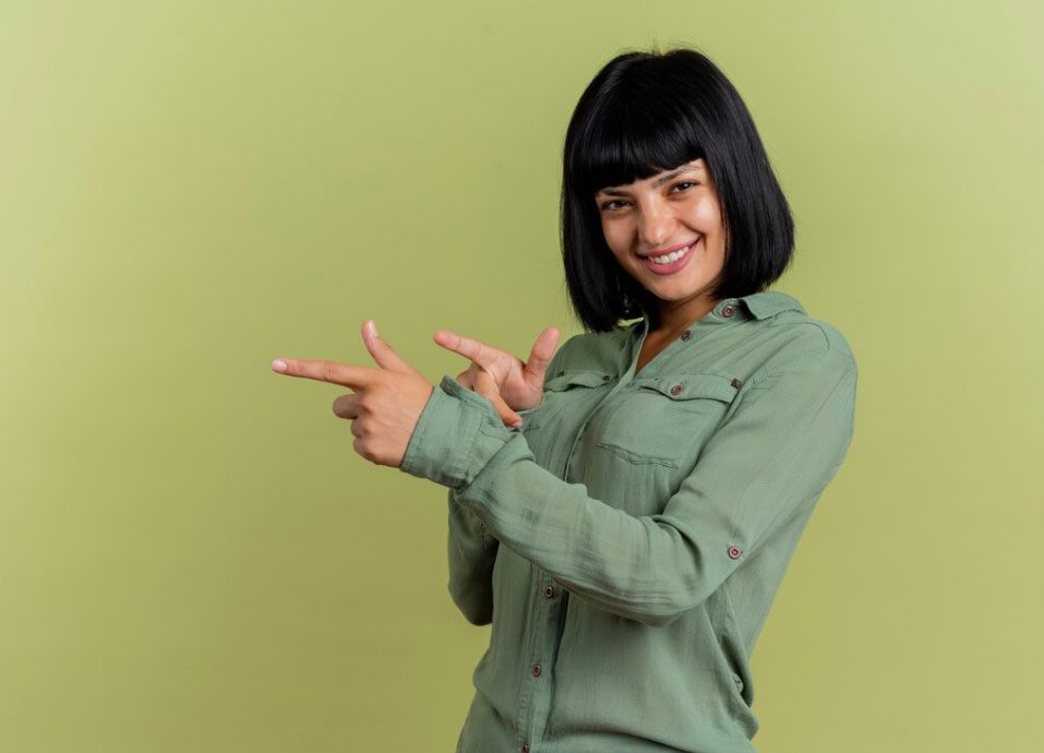 Young person pointing and smiling Young person pointing and smiling