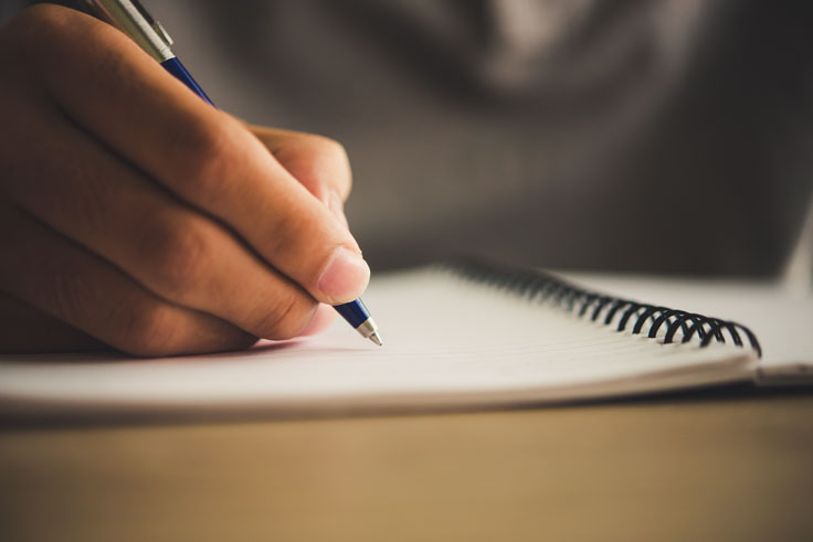 Hand writing on a piece of paper Hand writing on a piece of paper