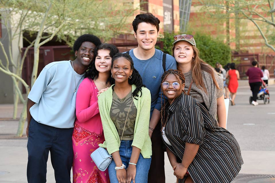 Group of students posing for a photo outside