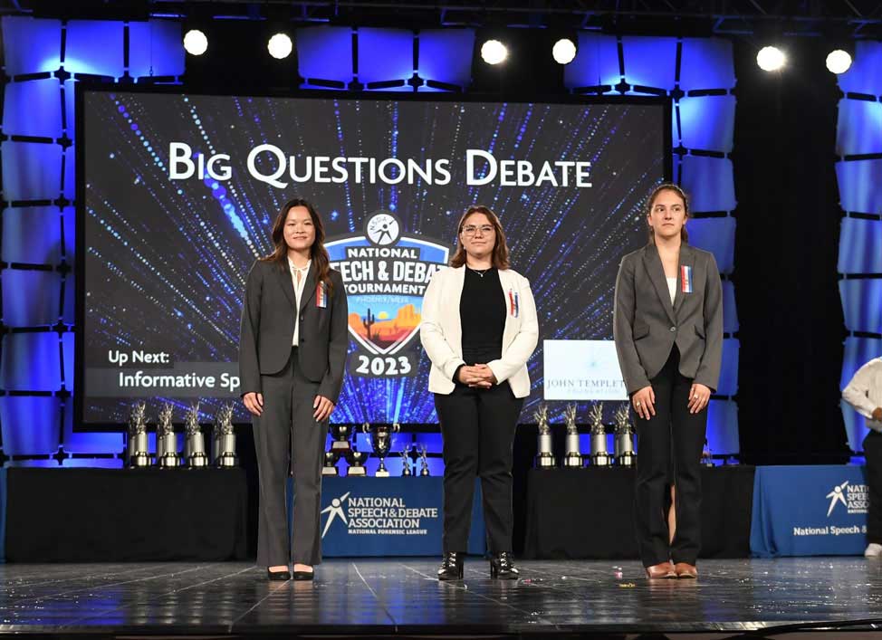 Group of students on the National Tournament stage with their trophies. Group of students on the National Tournament stage with their trophies.