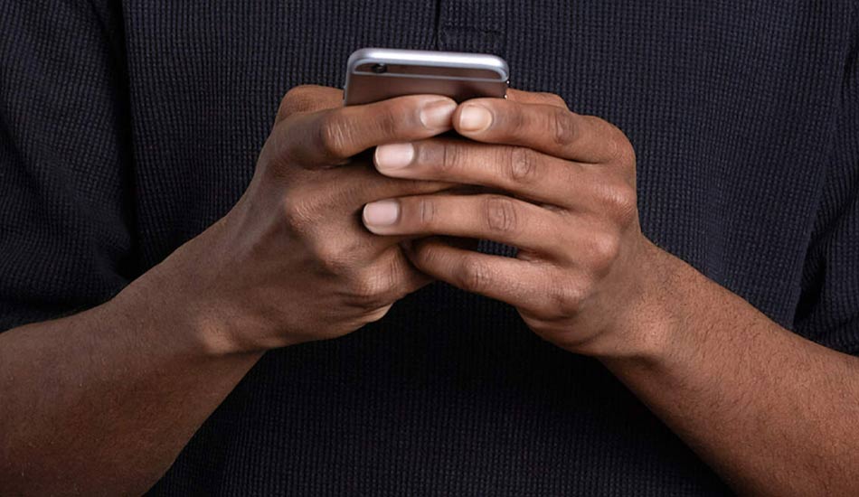 Person holding a cell phone in their hands