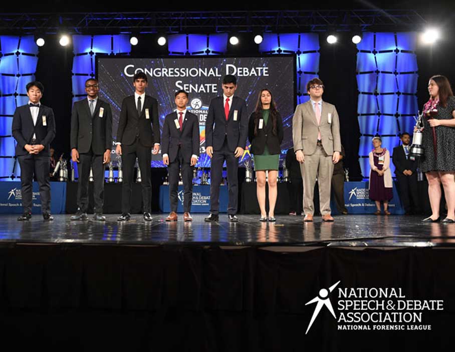 Group of students standing on stage at the National Tournament. Group of students standing on stage at the National Tournament.