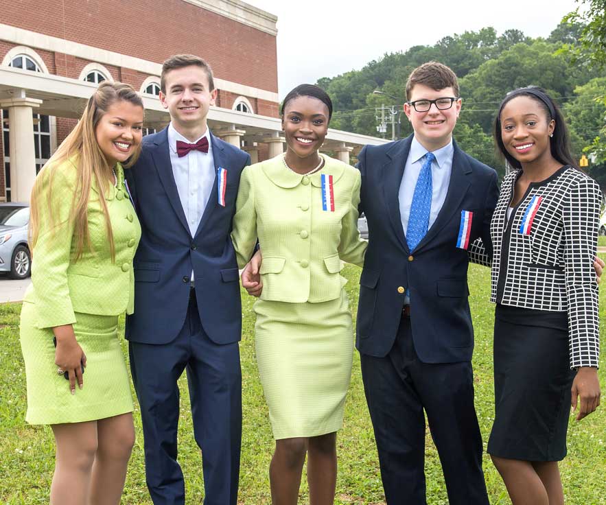 Group of students standing outside posing together