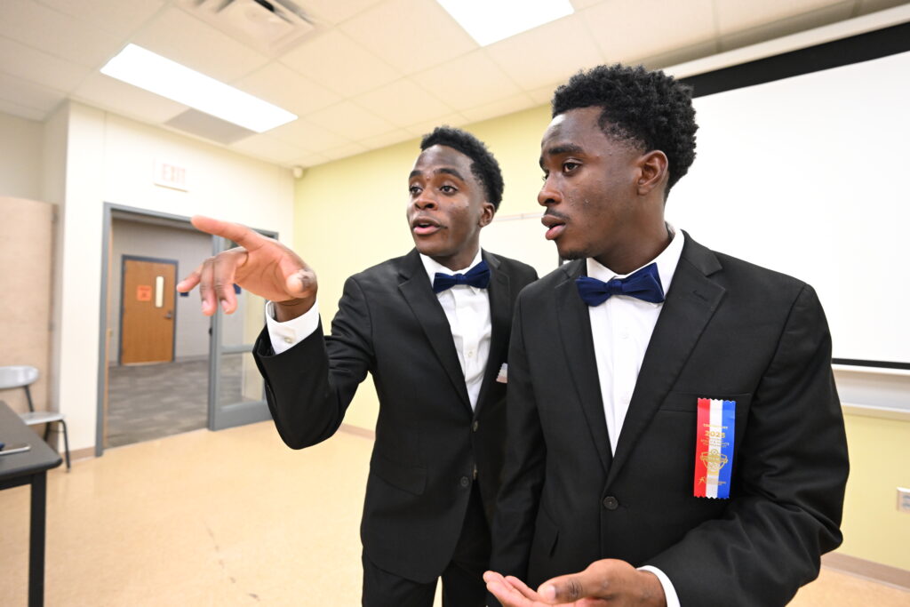 Two student performing in a classroom at a speech at a tournament
