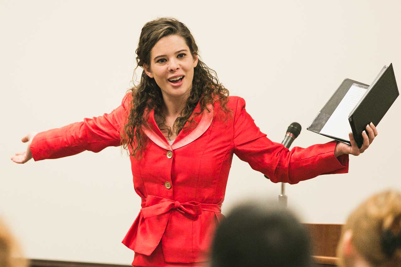 Student performing with binder in hand