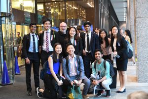 Group of students and coach posing for a photo opportunity