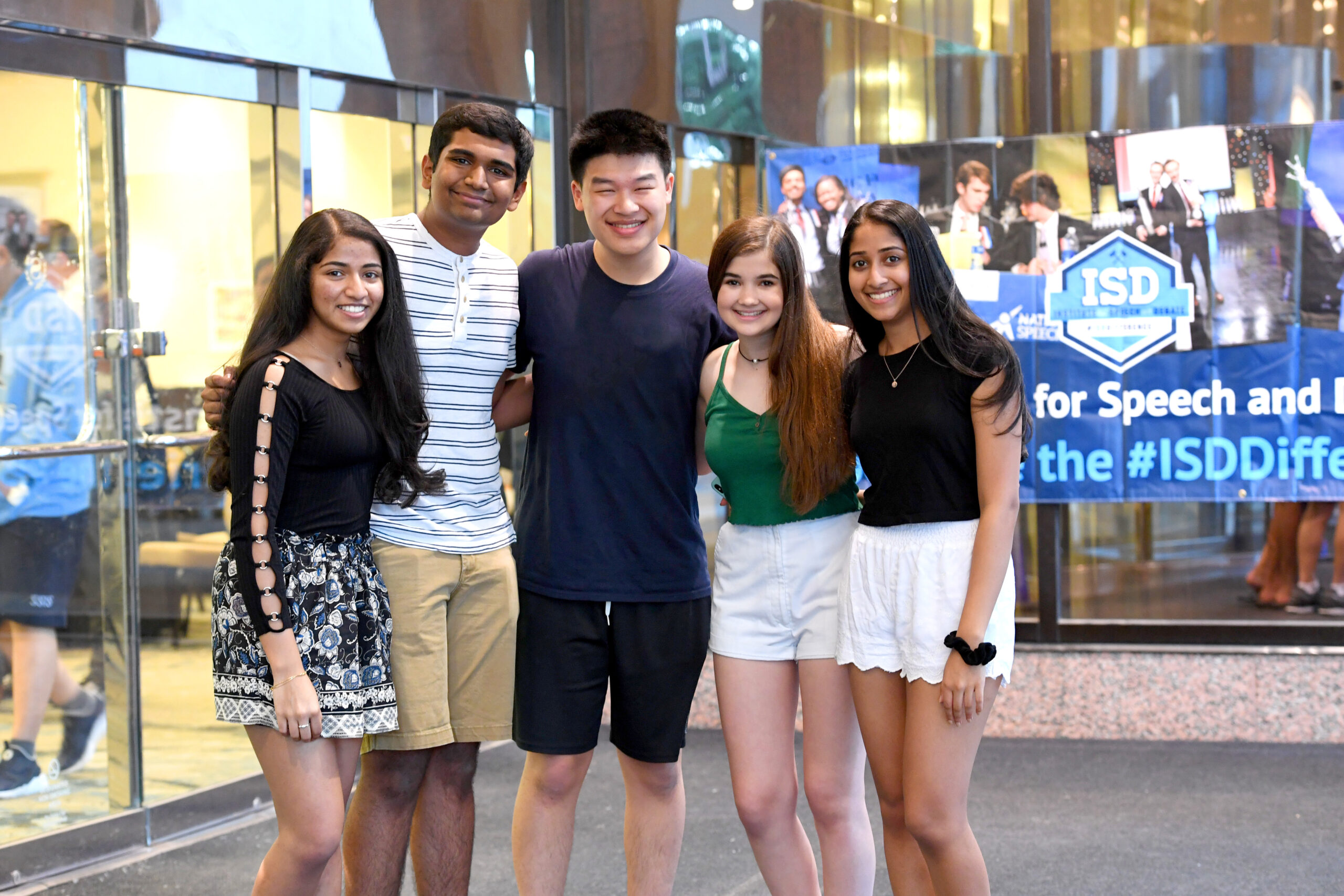 Group of students standing together arm in arm Group of students standing together arm in arm