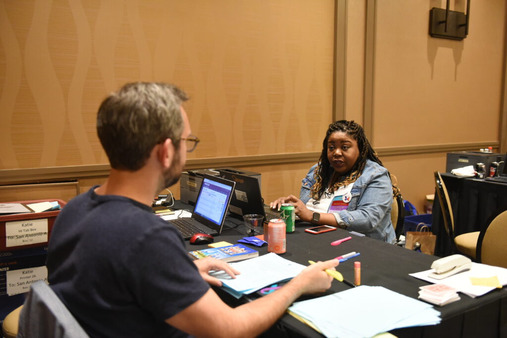 Two people having a discussion at a table.