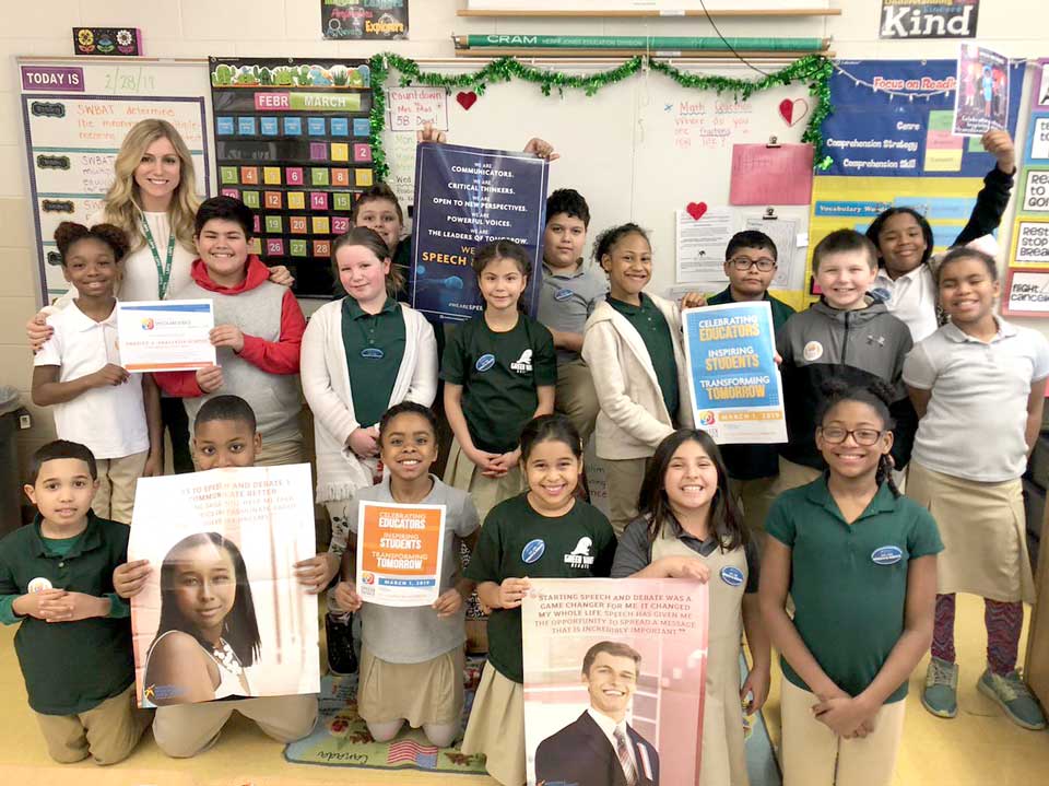 Classroom photo of a teacher with a large group of students