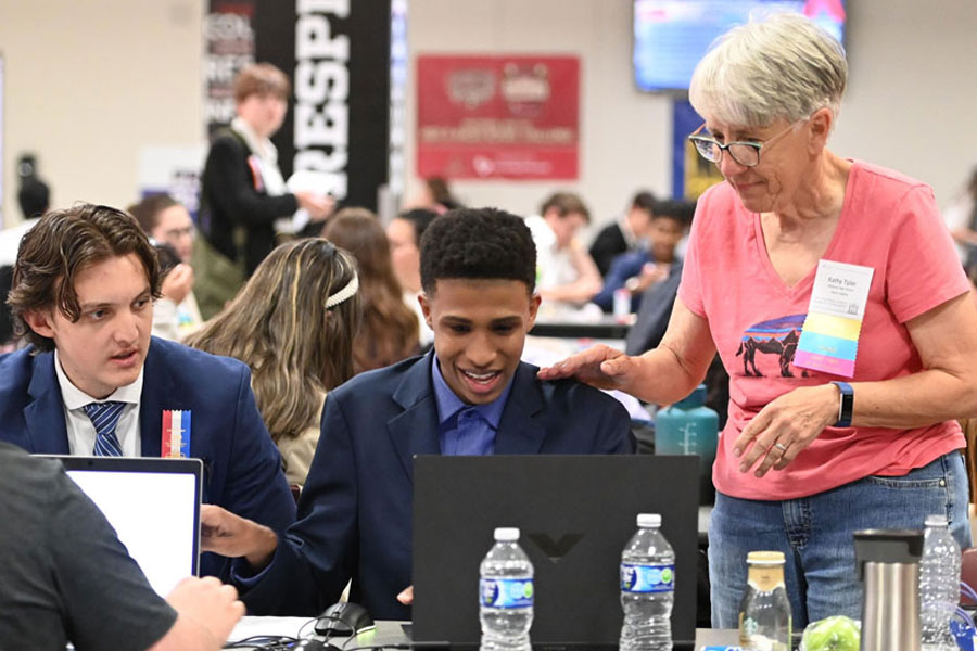 Coach helping students at a tournament