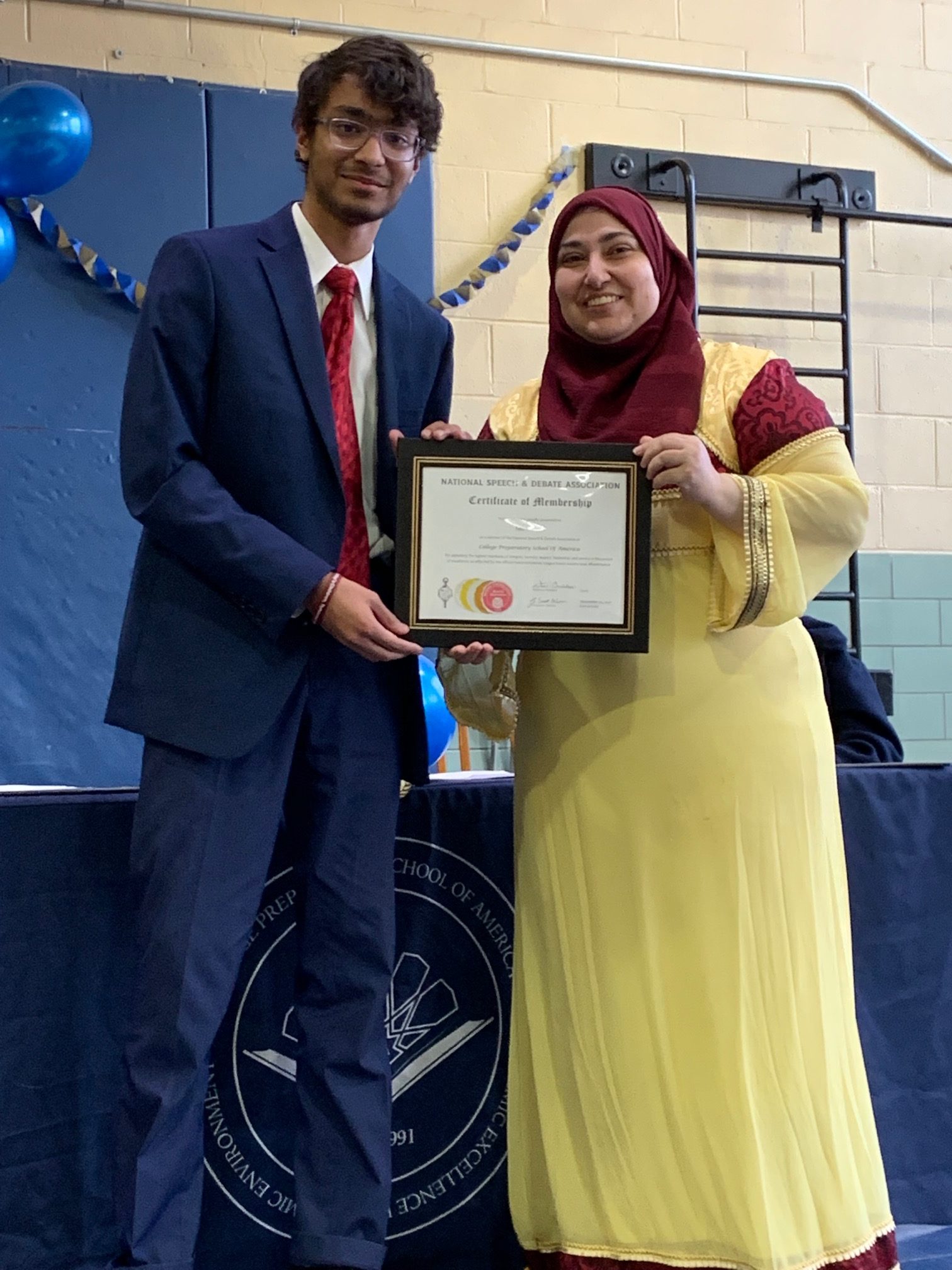 Two Students showing their Honor Society certificates Two Students showing their Honor Society certificates