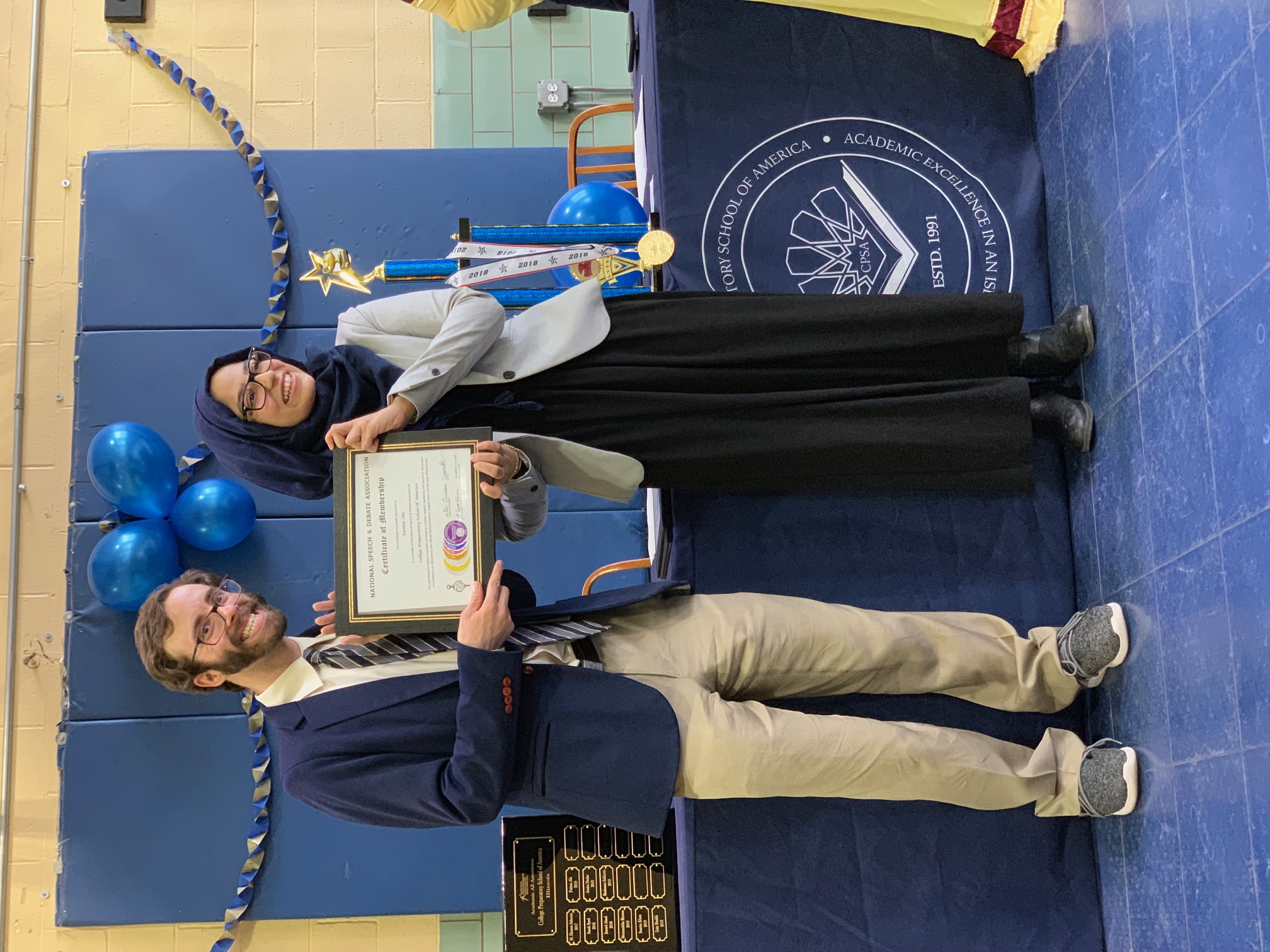 Student becoming new members of the Honor Society posing with their certificate