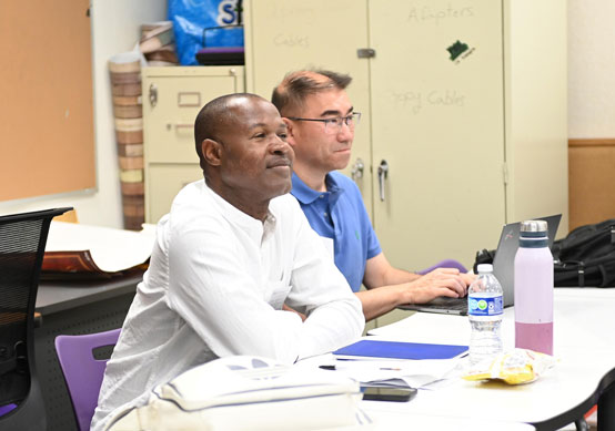 Two judges watch a round at the National Tournament