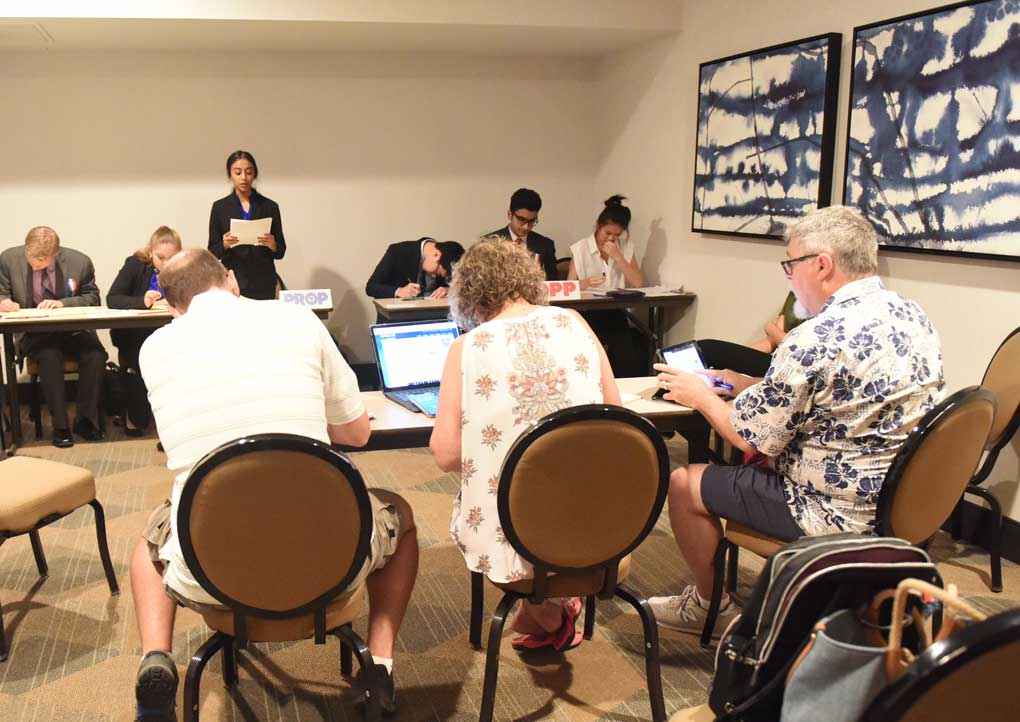 Group of Judges in a room watching students perform