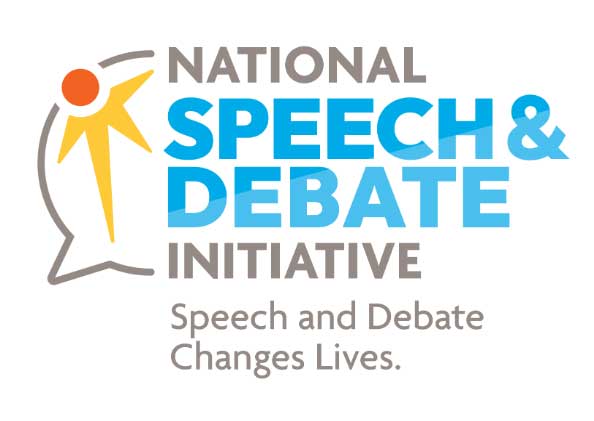 Group of students sitting at desks in a classroom talking.