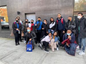 Group of students standing outside a building posing for a picture