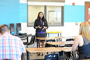 Coach talking to students in a classroom