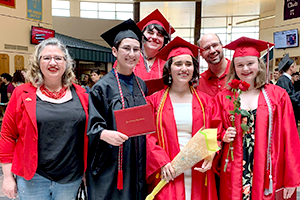 Students and Coach posing in cap and gown Students and Coach posing in cap and gown
