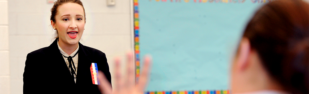 Student speaking in front of a class