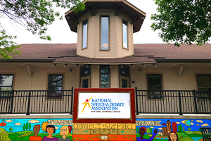 National Speech and Debate Association Building with Banner on railing National Speech and Debate Association Building with Banner on railing