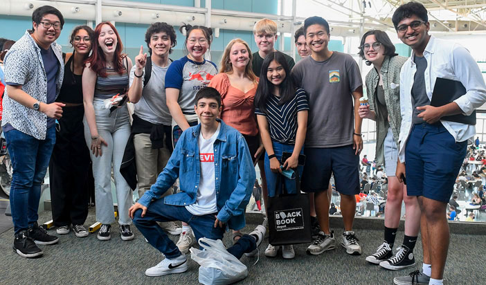 Group of students together at a tournament posing