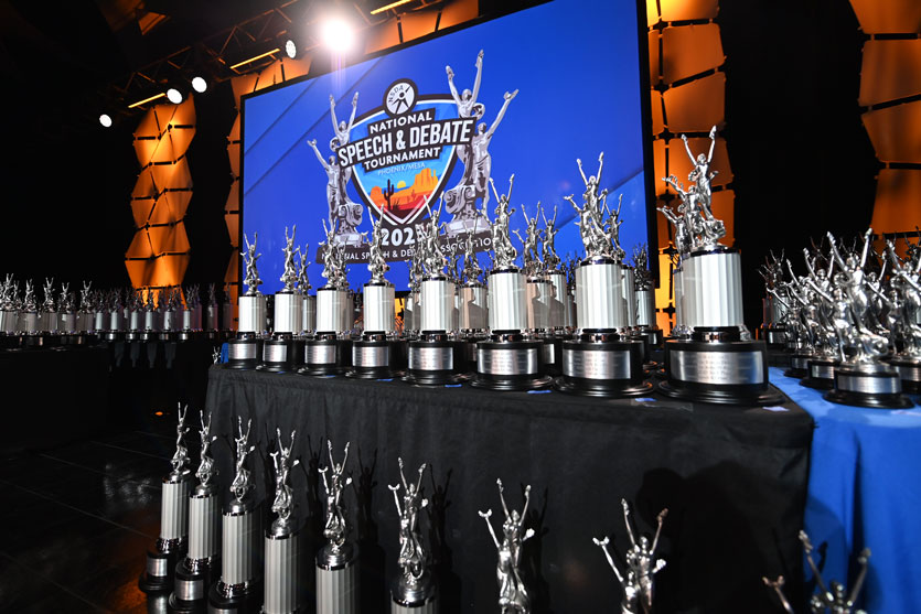 Group of trophies on a large tournament stage