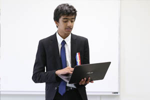 Person holding a laptop during a speech