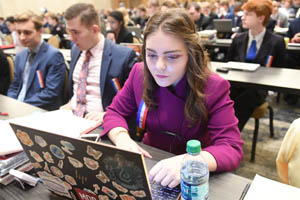 Person sitting at table working on a laptop