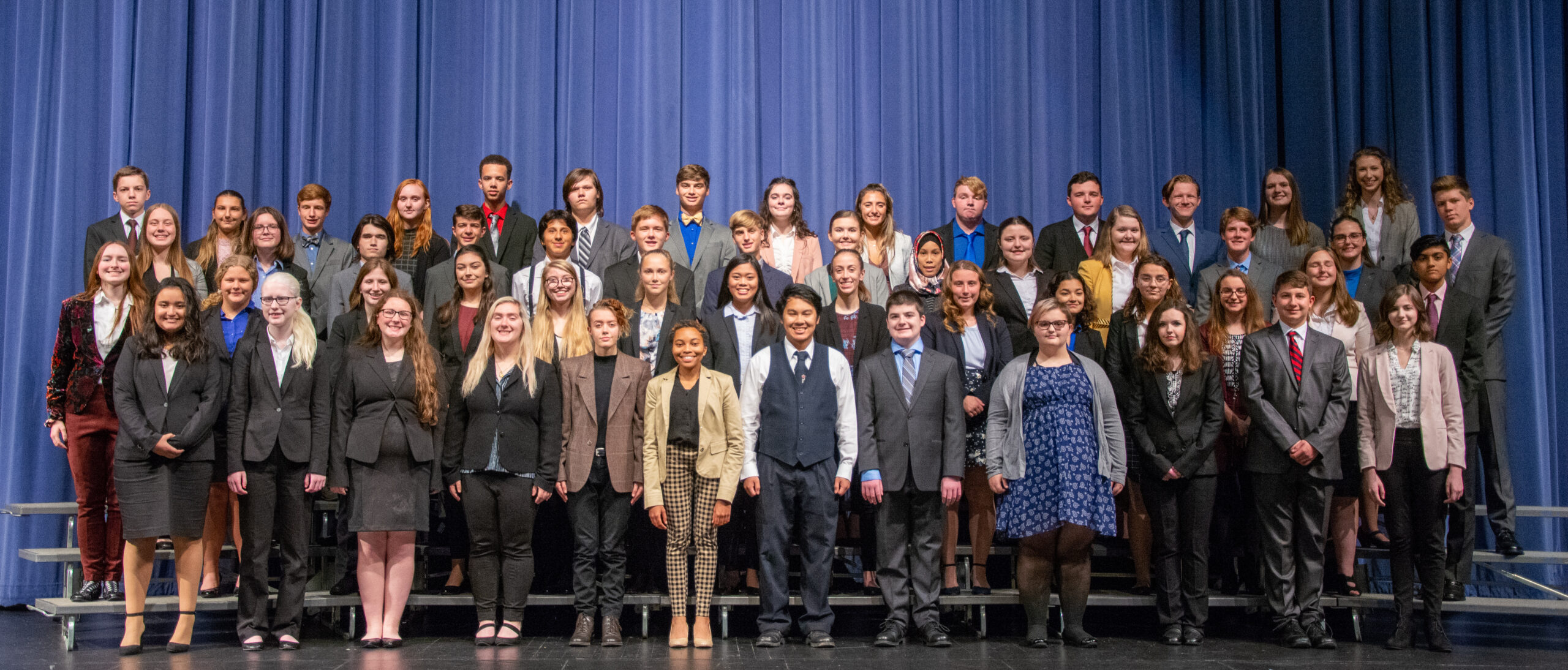 Group of students on a stage at a competition