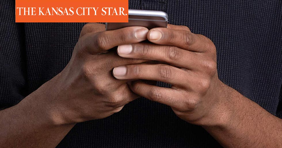 Image of hands holding a cellphone