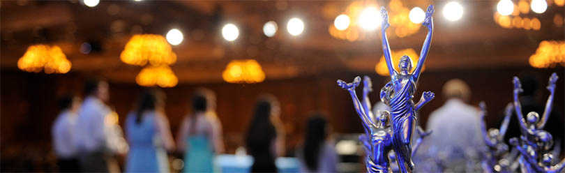 Group of students on stage with trophies at the National Tournament